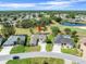 Beautiful golf course home with lush landscaping, large driveway, and mature trees near a pond at 9216 Tarleton Cir, Weeki Wachee, FL 34613