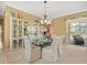 Bright dining room with glass table, elegant chairs and direct access to the outdoor pool area at 9216 Tarleton Cir, Weeki Wachee, FL 34613