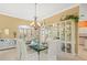 Bright dining room featuring a glass table, stylish chairs, and a beautiful display cabinet at 9216 Tarleton Cir, Weeki Wachee, FL 34613