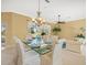 Inviting dining area with a glass table set for a meal, offering a view to the pool at 9216 Tarleton Cir, Weeki Wachee, FL 34613