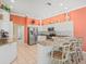 Stylish kitchen with white cabinetry, granite countertops, stainless steel appliances, and bar seating at 9216 Tarleton Cir, Weeki Wachee, FL 34613