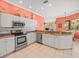 Bright kitchen with stainless steel appliances, granite countertops, and white cabinets at 9216 Tarleton Cir, Weeki Wachee, FL 34613