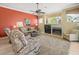 Cozy living room with fireplace, ceiling fan, and comfortable seating at 9216 Tarleton Cir, Weeki Wachee, FL 34613