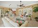 Bright living room with comfortable seating, large windows, and a view of the outdoor living space at 9216 Tarleton Cir, Weeki Wachee, FL 34613