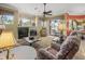 Bright living room featuring a fireplace, ceiling fan, and sliding glass doors to the outdoor patio at 9216 Tarleton Cir, Weeki Wachee, FL 34613