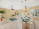 Open-concept living and dining areas with neutral colors, glass table, and a ceiling fan at 9216 Tarleton Cir, Weeki Wachee, FL 34613