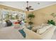 Airy living room featuring comfortable furniture, natural light, and a relaxing view of the pool area at 9216 Tarleton Cir, Weeki Wachee, FL 34613