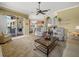 Spacious living room leading to the outside lanai, featuring neutral tones at 9216 Tarleton Cir, Weeki Wachee, FL 34613