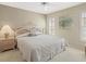 Serene main bedroom features a ceiling fan, neutral walls, and abundant natural light at 9216 Tarleton Cir, Weeki Wachee, FL 34613