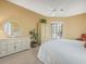Comfortable main bedroom featuring a dresser, plantation shutters, and a cozy ambiance at 9216 Tarleton Cir, Weeki Wachee, FL 34613