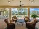 Covered patio with four chairs, a ceiling fan, and view of a swimming pool at 9216 Tarleton Cir, Weeki Wachee, FL 34613