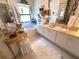 Bright bathroom with soaking tub, dual sinks, vanity table, and decorative accents throughout at 9311 Haas Dr, Hudson, FL 34669