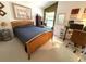 Bedroom with a wood bed, desk, and reading nook by the window at 9311 Haas Dr, Hudson, FL 34669