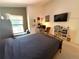 A cozy bedroom featuring a window seat, neutral walls, and a dedicated workspace at 9311 Haas Dr, Hudson, FL 34669