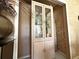 Dining room featuring a hutch with glass doors and interior shelving at 9311 Haas Dr, Hudson, FL 34669