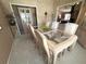 Dining room featuring a glass table, six chairs, carpet, and a hutch at 9311 Haas Dr, Hudson, FL 34669