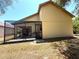 Rear exterior view of the home showing the enclosed screened in patio area and back yard at 9311 Haas Dr, Hudson, FL 34669