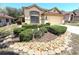 A charming single Gathering home with a manicured front yard with decorative rocks and lush bushes at 9311 Haas Dr, Hudson, FL 34669