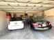 Spacious two-car garage with storage racks and overhead door with a garage door opener at 9311 Haas Dr, Hudson, FL 34669