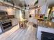 Beautiful kitchen features light wood cabinets, granite countertops, stainless steel appliances and wood look floor at 9311 Haas Dr, Hudson, FL 34669