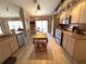 Open kitchen with stainless steel appliances, granite countertops, island and wood look flooring at 9311 Haas Dr, Hudson, FL 34669