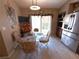 Sunlit dining area with large windows and views adjacent to a modern stainless steel kitchen at 9311 Haas Dr, Hudson, FL 34669