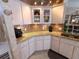 Stylish kitchen with granite countertops, tiled backsplash, and modern appliances on light wood floors at 9311 Haas Dr, Hudson, FL 34669