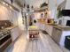 Bright kitchen with stainless steel appliances, granite countertops, wood cabinets and decorative accents at 9311 Haas Dr, Hudson, FL 34669