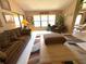 Living room with vaulted ceilings, sitting area, and view of the dining room at 9311 Haas Dr, Hudson, FL 34669