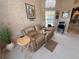 Bright living room with plush neutral carpet, large windows and a comfortable tan leather couch at 9311 Haas Dr, Hudson, FL 34669