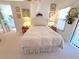 Cozy bedroom with warm lighting, decorative wall art, and an inviting queen-sized bed at 9311 Haas Dr, Hudson, FL 34669
