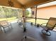 Comfortable screened patio perfect for entertaining, with ceiling fan and outdoor furniture at 9311 Haas Dr, Hudson, FL 34669