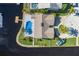 Aerial view of waterfront home featuring a private pool, dock, and lush landscaping at 9930 San Diego Way, Port Richey, FL 34668