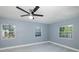 Spacious bedroom featuring a contemporary ceiling fan and three windows offering ample natural light at 9930 San Diego Way, Port Richey, FL 34668