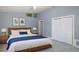 Comfortable bedroom features a ceiling fan, blue accents, wood furnishings, and natural light at 9930 San Diego Way, Port Richey, FL 34668