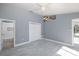 Bright bedroom with ensuite bathroom, ceiling fan, and natural light at 9930 San Diego Way, Port Richey, FL 34668
