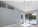Light bedroom with access to pool and view of the backyard at 9930 San Diego Way, Port Richey, FL 34668