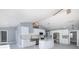 Spacious kitchen with stainless steel appliances, white cabinets, an island, and an open layout at 9930 San Diego Way, Port Richey, FL 34668