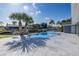 Outdoor pool with palms and a view of the canal at 9930 San Diego Way, Port Richey, FL 34668