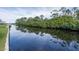 Calm waterway with lush green banks at 9930 San Diego Way, Port Richey, FL 34668