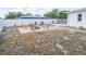 Spacious backyard featuring a brick fire pit, chair seating and partial view of neighbor's house at 9942 Woodridge Ct, Port Richey, FL 34668