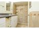 Bathroom featuring a tiled shower and vanity with decorative sink at 9942 Woodridge Ct, Port Richey, FL 34668