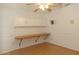 Bedroom with built in desk and cabinets plus a bright ceiling fan at 9942 Woodridge Ct, Port Richey, FL 34668