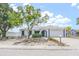 Well-kept home with mature landscaping, front yard tree, and an attached two-car garage at 9942 Woodridge Ct, Port Richey, FL 34668