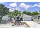 Charming single-story home with a well-manicured front yard, blue skies, and inviting curb appeal at 9942 Woodridge Ct, Port Richey, FL 34668
