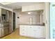 Kitchen featuring stainless steel refrigerator and kitchen island bar with seating at 9942 Woodridge Ct, Port Richey, FL 34668