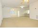 Spacious living room area leading to other spaces in the house, featuring overhead lighting at 9942 Woodridge Ct, Port Richey, FL 34668