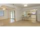 Open-concept living and dining area featuring wood floors and access to the kitchen at 9942 Woodridge Ct, Port Richey, FL 34668