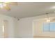 Bright living room featuring ceiling fans and an arched doorway leading to another room at 9942 Woodridge Ct, Port Richey, FL 34668