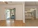 Inviting living area featuring hardwood flooring and seamless flow into the modern kitchen at 9942 Woodridge Ct, Port Richey, FL 34668